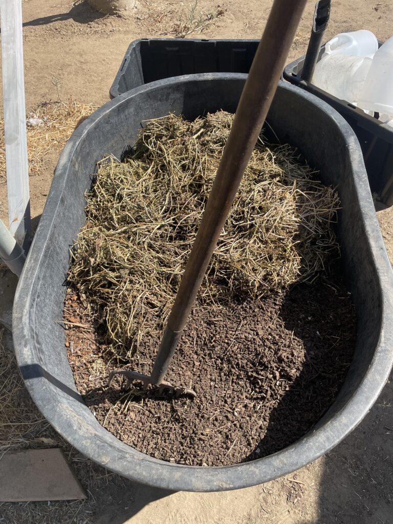 Tub containing arbor mulch, alfalfa hay and prepared organic material for composting worms